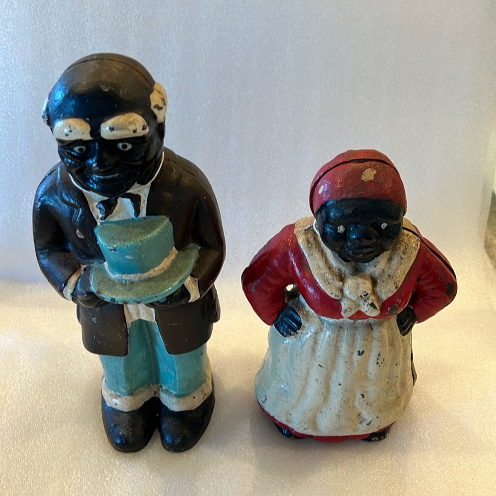 Pair of vintage African American cast iron coin banks.